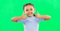 Thumbs up, happy and child in agreement excited, winning and girl kid isolated in studio green screen background. Yes Royalty Free Stock Photo