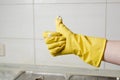 Female hand in yellow glove showing thumb up Royalty Free Stock Photo