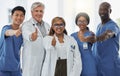 Thumbs up portrait, doctors and team of nurses together in happy hospital. Face, like hand and medical professionals Royalty Free Stock Photo