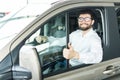 Thumbs up. Portrait of a happy businessman showing thumbs up sitting in his new car Royalty Free Stock Photo