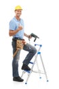 Thumbs up, portrait and repairman in a studio with a drill, tool belt and ladder for maintenance. Happy, smile and male Royalty Free Stock Photo