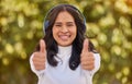 Thumbs up, relax and woman in park with headphones on listening to music on weekend. Freedom, happiness and portrait of Royalty Free Stock Photo