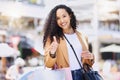 Thumbs up, shopping and retail with a woman customer on the search for a sale, bargain or deal in an outdoor mall. Thank