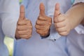 Thumbs up team hand satisfaction job with positive happy good sign. Close up business people partner hand Positive idea good sign Royalty Free Stock Photo