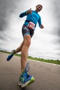 Thumbs-up triathlete runs during triathlon competition, bottom view