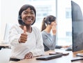 Thumbs up, woman with headset and on a computer desk in her office at work. Telemarketing or customer service, online Royalty Free Stock Photo