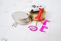 thumbtack marked on end of month on white calendar and blurred white car and stack of coins with pay day text Royalty Free Stock Photo
