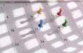 Thumbtacks of various colors pin on calendar Royalty Free Stock Photo