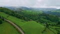 Thunder clouds covering green hills landscape aerial. Mountains gloomy weather Royalty Free Stock Photo