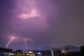 Thunder light striking over a mountain . Heavy Rainfall . Thunderstorm .