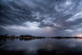 Thunder storm above the lake with lightnings Royalty Free Stock Photo