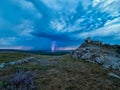 Thunderbolts,lightning on a cloudy evening blue sky over old Enisala stronghold,citadel