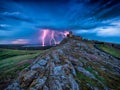 Thunderbolts lightning on a cloudy evening blue sky over old Enisala stronghold citadel Royalty Free Stock Photo