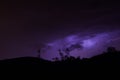 Thunderbolts over the mountains with purple sky Royalty Free Stock Photo