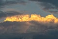 Lit yellow sunlight thundercloud at sunset
