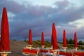 Thunderclouds are Approaching the Tourist City, the Beach. A Strong Wind Blows from the Sea to the Beach and Beach Umbrellas. The Royalty Free Stock Photo