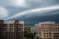 Thunderclouds go to the city. Cityscape with stormy sky