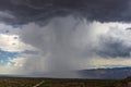 Thunderhead cloud produces rain shower over semi-desert grassland prairie Royalty Free Stock Photo