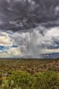 Thunderhead cloud produces rain shower over semi-desert grassland prairie Royalty Free Stock Photo