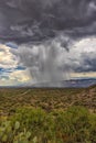 Thunderhead cloud produces rain shower over semi-desert grassland prairie Royalty Free Stock Photo