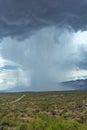 Thunderhead cloud produces rain shower over semi-desert grassland prairie Royalty Free Stock Photo