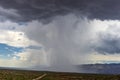 Thunderhead cloud produces rain shower over semi-desert grassland prairie Royalty Free Stock Photo