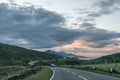 Thunderstorm clouds at sunset in the Scottish highlands crossed by a road Royalty Free Stock Photo