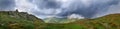 Thunderstorm dark clouds over mountain landscape panorama. Mount Gutyn Tomnatyk and glacial lake Brebenekul from the slopes