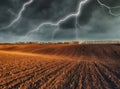 Thunderstorm in the field. huge lightning over a hilly field