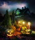 Lightning lit stormy pathway to haunted house, patio with Jack-o-Lanterns Royalty Free Stock Photo