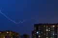 Thunderstorm with Lightning bolt strike over city. Moment lightning