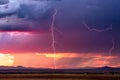 Thunderstorm lightning bolt strikes with sunset storm clouds Royalty Free Stock Photo