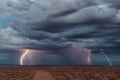 Thunderstorm with lightning bolts striking in the desert Royalty Free Stock Photo