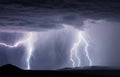 Thunderstorm lightning bolts striking a mountain Royalty Free Stock Photo