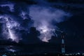 Forked lightning over the cell phone antenna tower at night Royalty Free Stock Photo