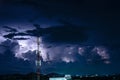 Forked lightning over the cell phone antenna tower at night Royalty Free Stock Photo