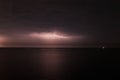 Thunderstorm with lightning over the sea at night. Lightning flashes and storm clouds Royalty Free Stock Photo