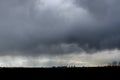 Thunderstorm over the city on a summer evening. Monstrous clouds over industrial buildings. Apocalyptic landscape