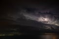 Thunderstorm over the sea, lightning beats the water