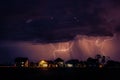 Thunderstorm with two lightnings hitting buildings around the town