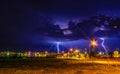 Thunderstorm with two lightnings hitting buildings around the town