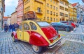 Thunovska Street with parked vintage Citroen 2CV, on March 6 in Prague, Czech Republic
