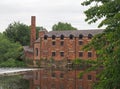 Thwaite mill leeds built in 1825 on an island between the river aire and calder navigation canal reflected in the water Royalty Free Stock Photo