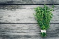 Thyme bunch. Bundle of fresh thymes on a wooden background. Retro magazine picture. Copy space Royalty Free Stock Photo