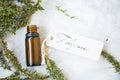 Thyme essential oil bottle with thyme herb twigs and label on concrete background, spa essential oil bottle Royalty Free Stock Photo