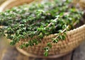 Thyme herb in basket on wooden table. Royalty Free Stock Photo