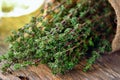 Thyme herb in basket on wooden table. Royalty Free Stock Photo