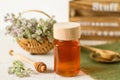 Thyme honey in a jar on a white wooden background