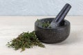 Thyme on wooden kitchen surface and mortar and pestle Royalty Free Stock Photo