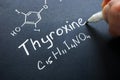 Thyroxine hormone sign on a black paper